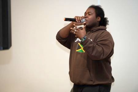 Young man singing into microphone