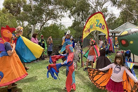 Children dressed in colourful bird and butterfly costumes