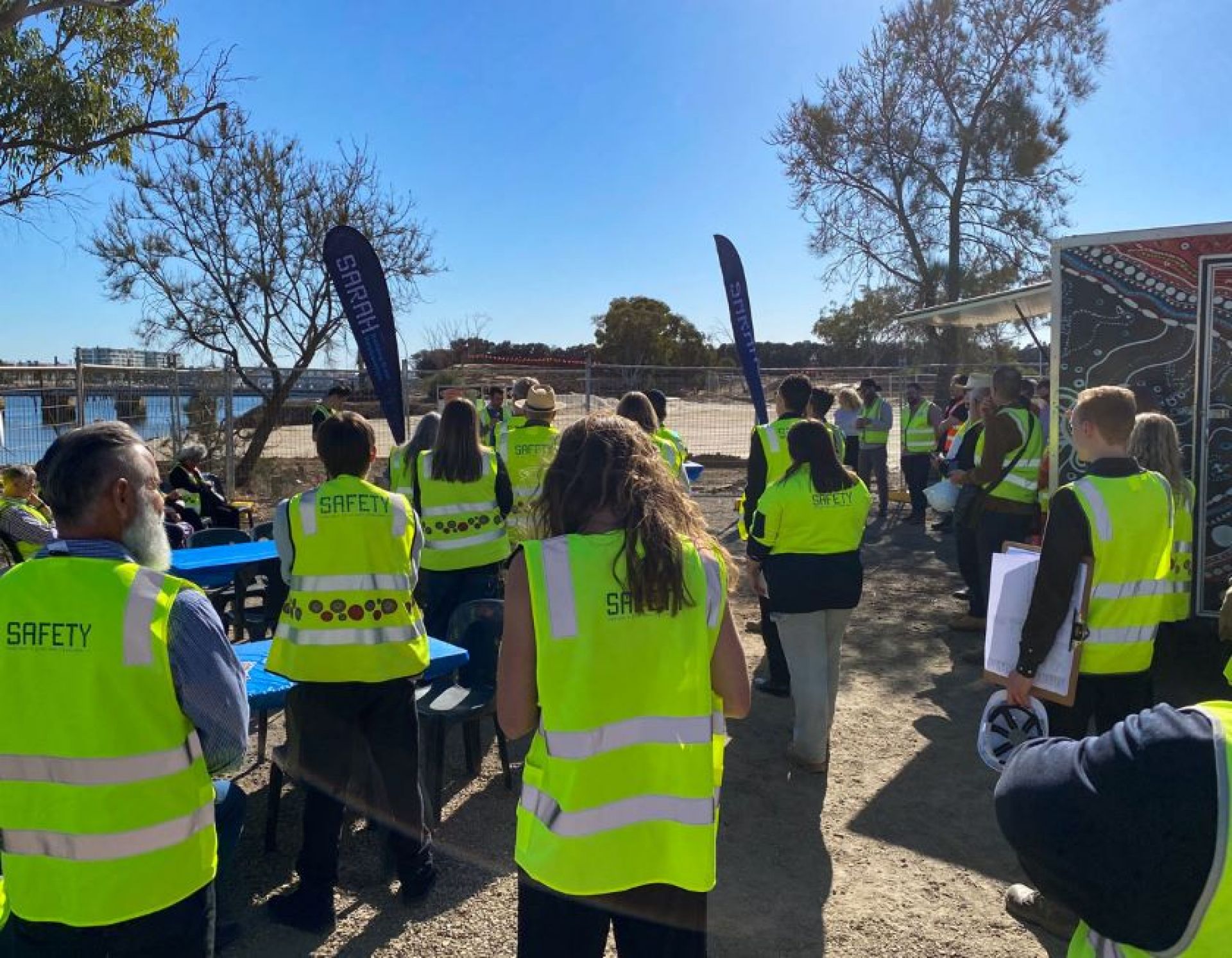 Group of people listening to a talk at a construction site