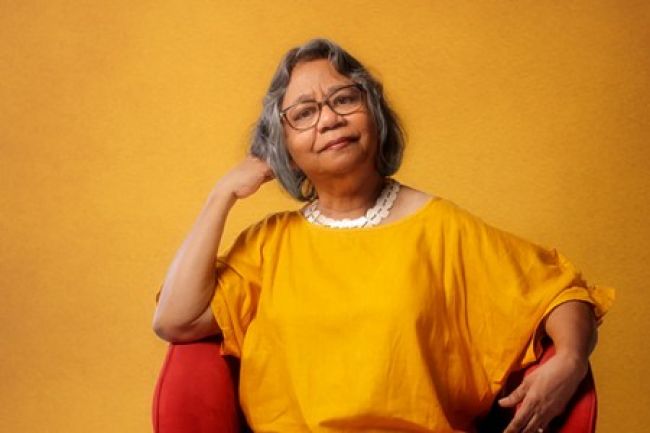 Yidinji activist Henrietta Marrie AM on red chair