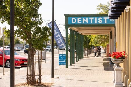 Suburban street with footpath and signs outside businsses