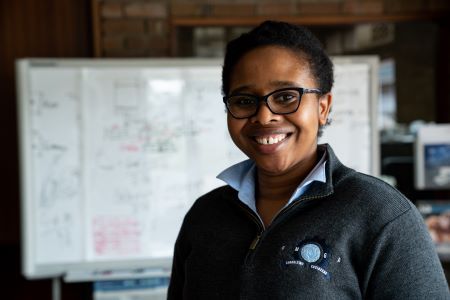 Smiling woman wearing an Omega Consulting uniform