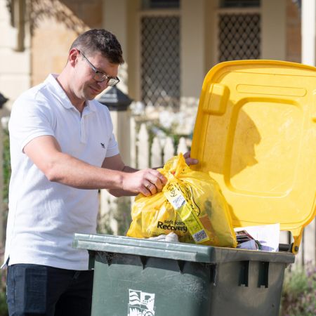 man putting soft plastics into bin