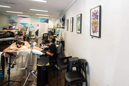 Tattoo artist working in a gallery