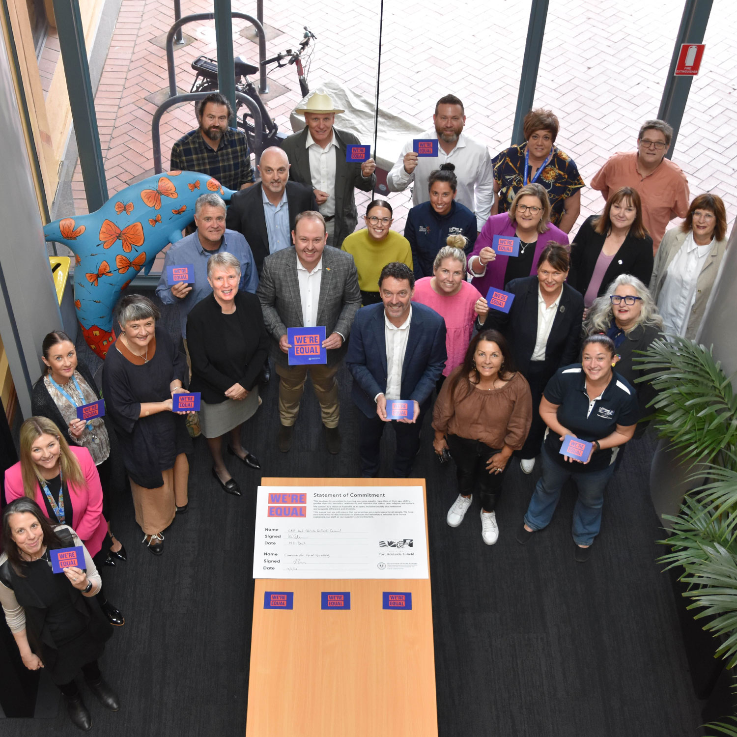 staff at the civic centre holding we're equal signs.